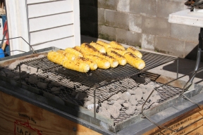 remainder of the corn being grilled for sides over the pig charcoals, brushed with drippings